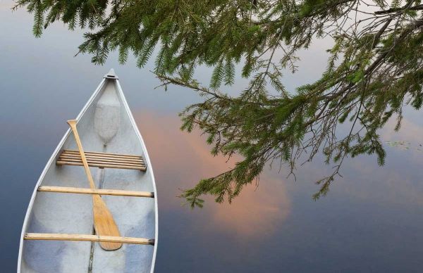 Canada, Quebec, Eastman Canoe on lake at sunset
